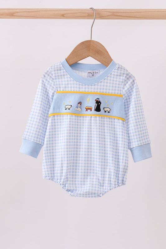 Baby romper with checkered pattern and embroidered design on a wooden hanger against a light background