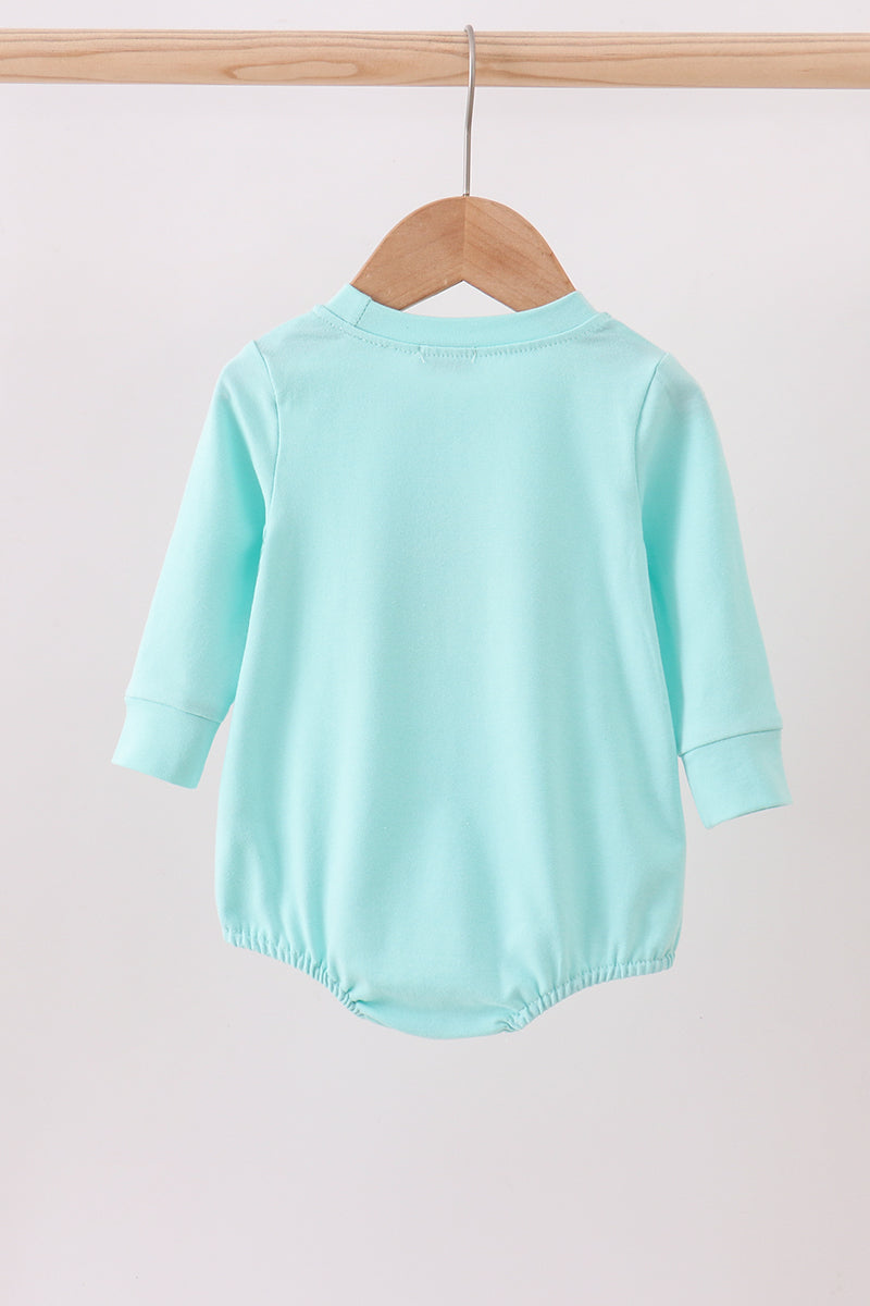 Mint green baby romper on a wooden hanger against a white background