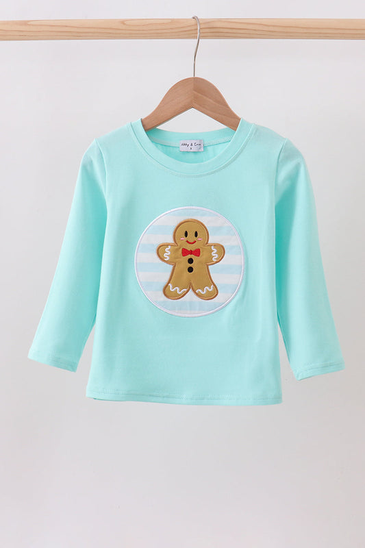 Light blue long-sleeve shirt with a gingerbread man design on a wooden hanger against a white background