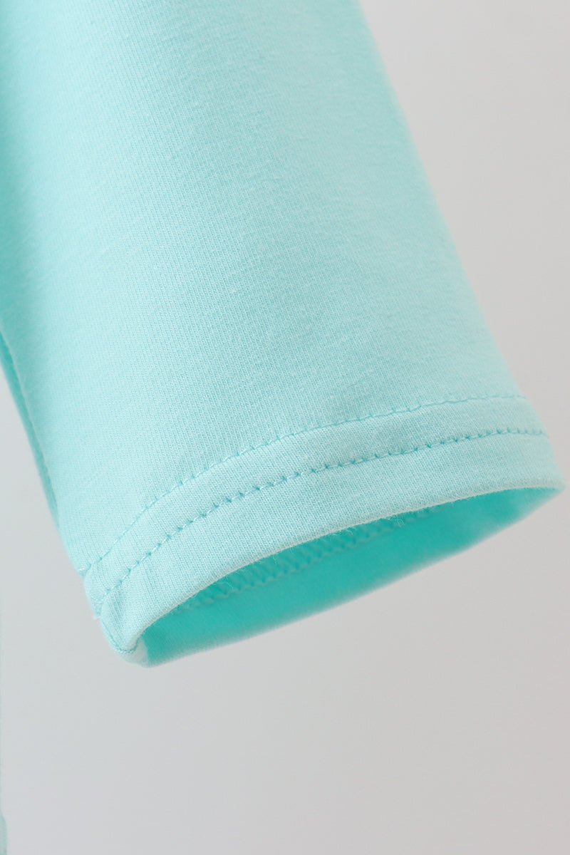 Close-up of a light blue sleeve on a plain background