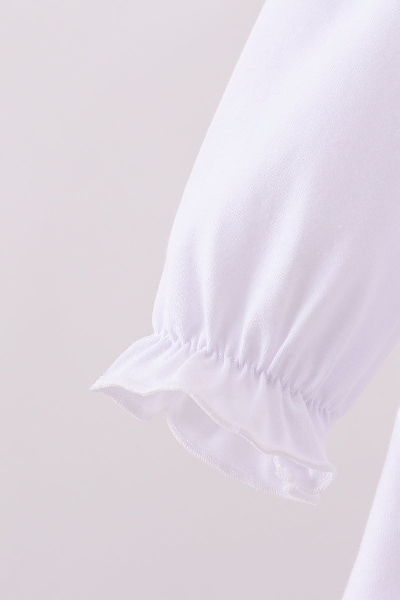 Close-up of a white blouse with ruffled sleeves on a light gray background