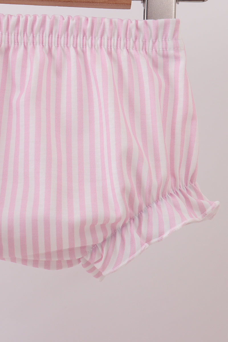Pink striped fabric on a wooden surface