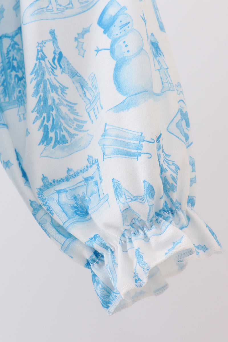 Blue winter-themed pattern on white fabric