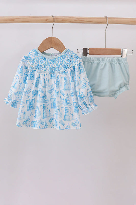 Baby girl's outfit with blue patterned top and light blue bloomers on a wooden hanger against a white background.