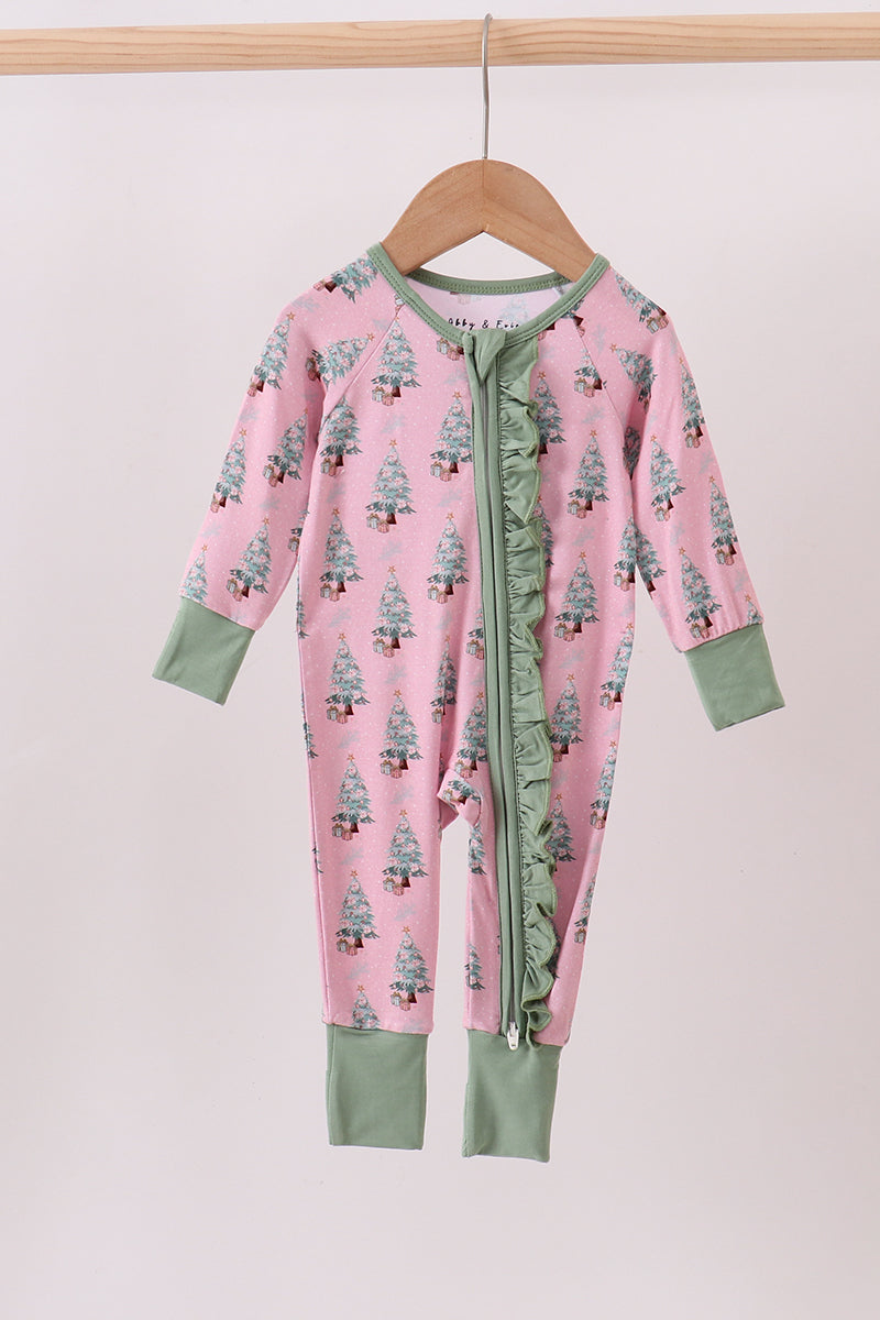 Pink baby onesie with green accents on a wooden hanger against a white background