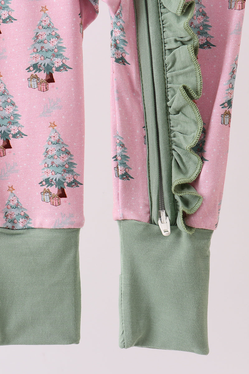 Pink pajama set with Christmas tree pattern and green ruffled trim on a light pink background