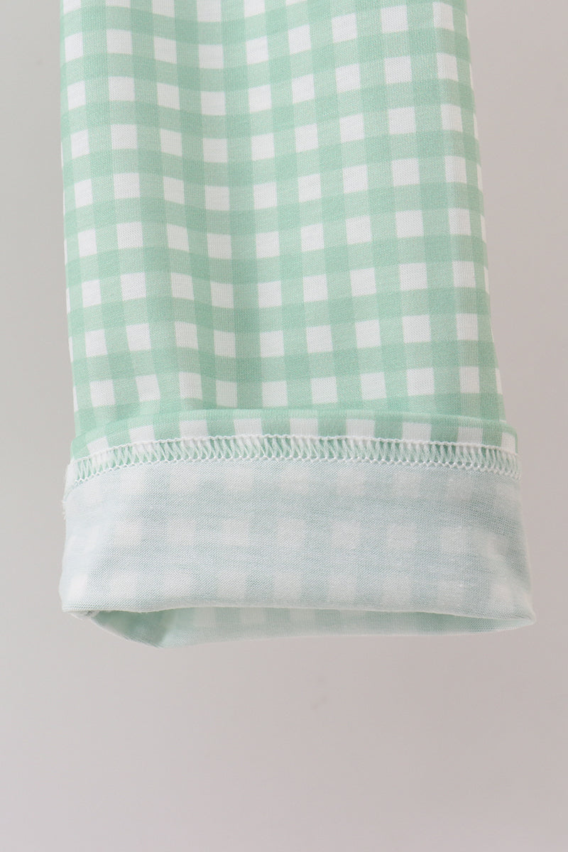 Green and white checkered fabric on a gray background