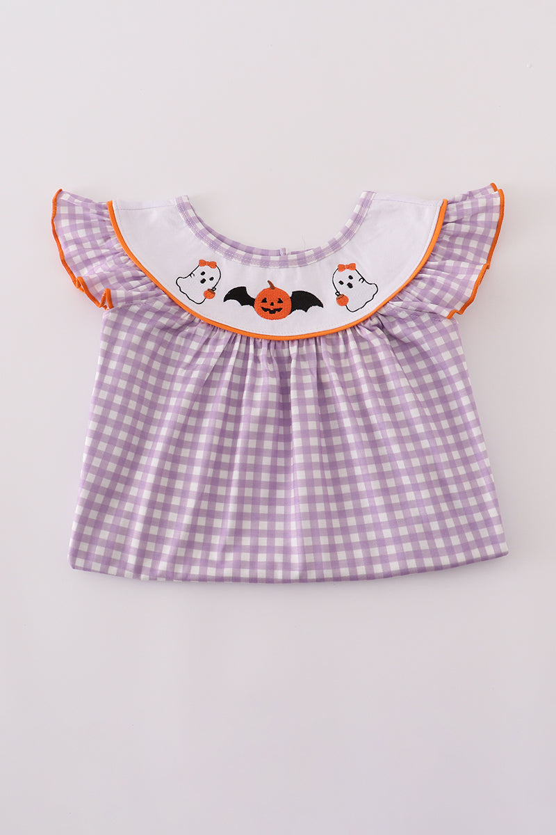 Purple checkered top with Halloween-themed embroidery on a light gray background