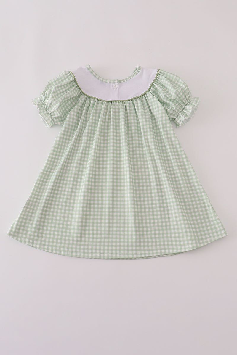 Green checkered dress with white collar on a light gray background