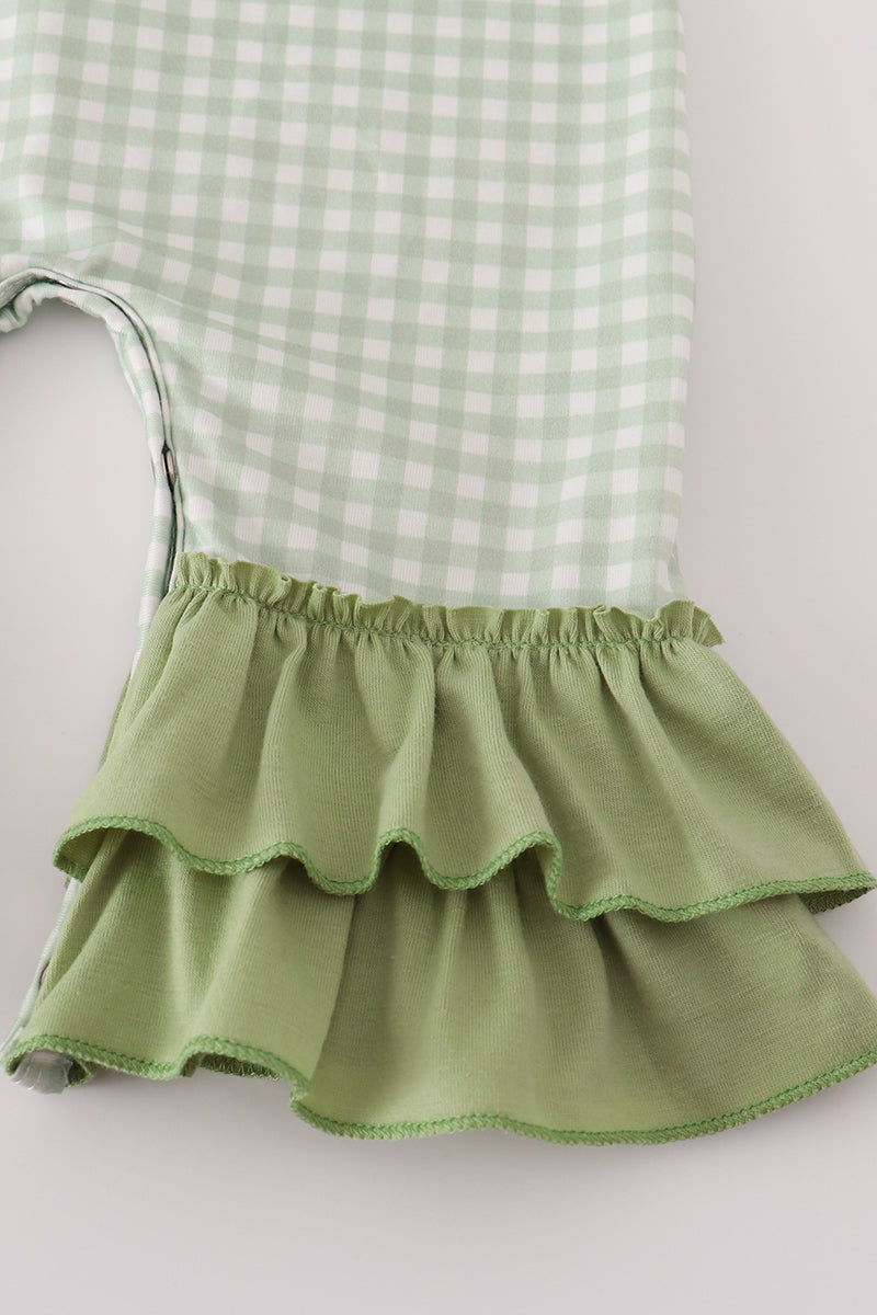 Green checkered top with a ruffled green skirt on a light background