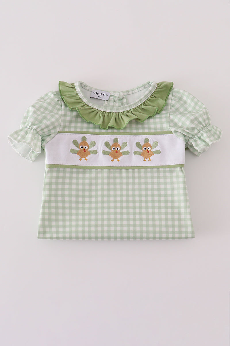 Green checkered dress with embroidered details on a white background