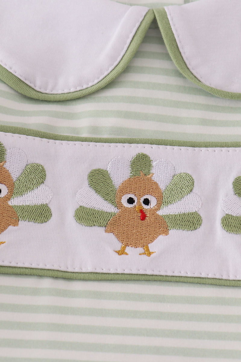 Striped fabric with embroidered owl design and green trim