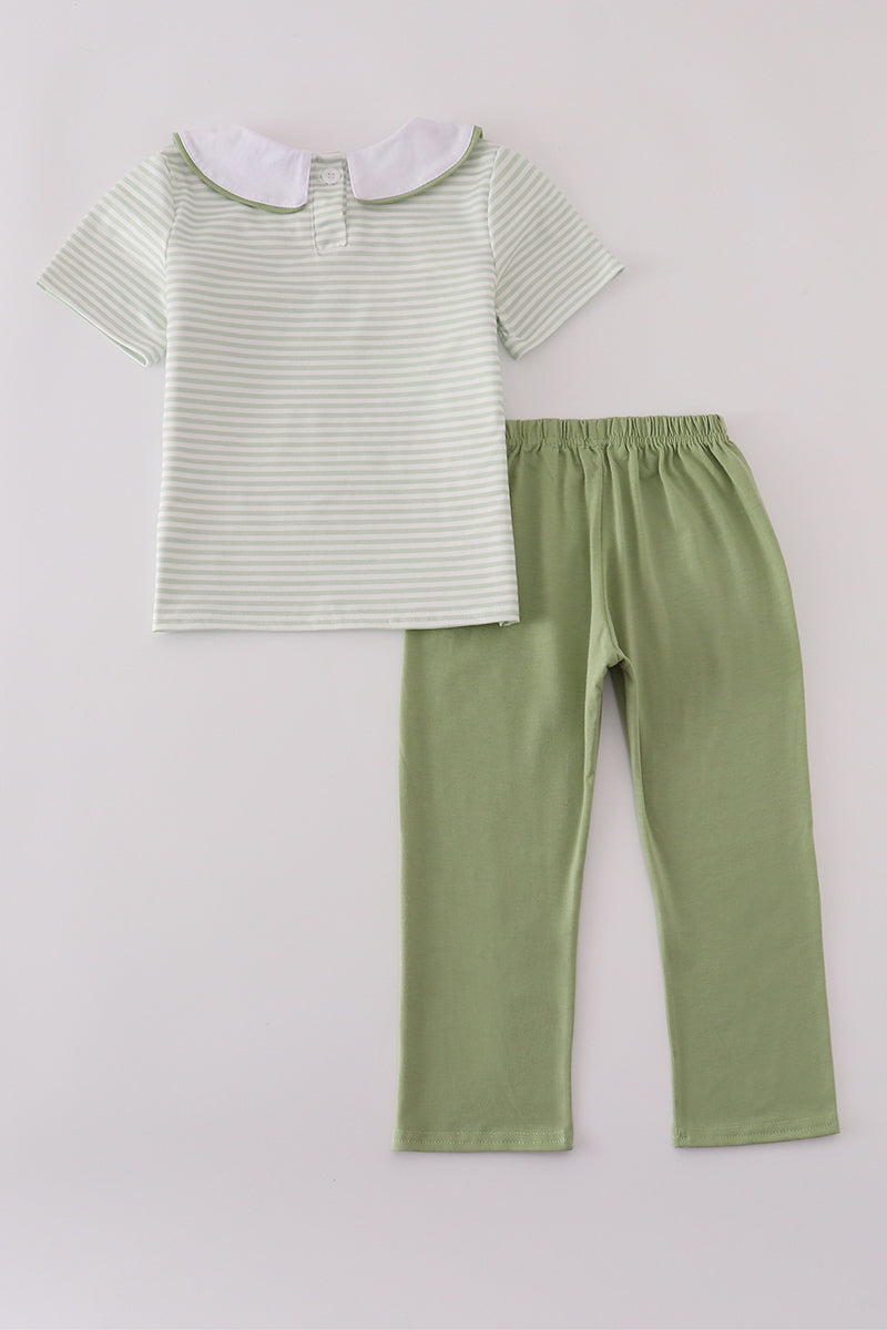 Striped shirt and green pants on a light gray background