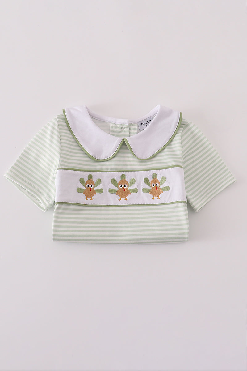 Green striped shirt with white collar and embroidered design on a light gray background