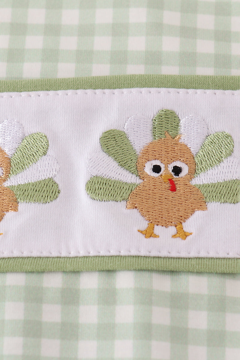 Embroidered turkeys on a green and white checkered fabric