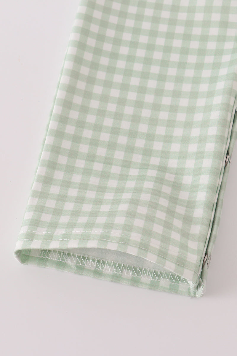 Green and white checkered fabric on a light gray background