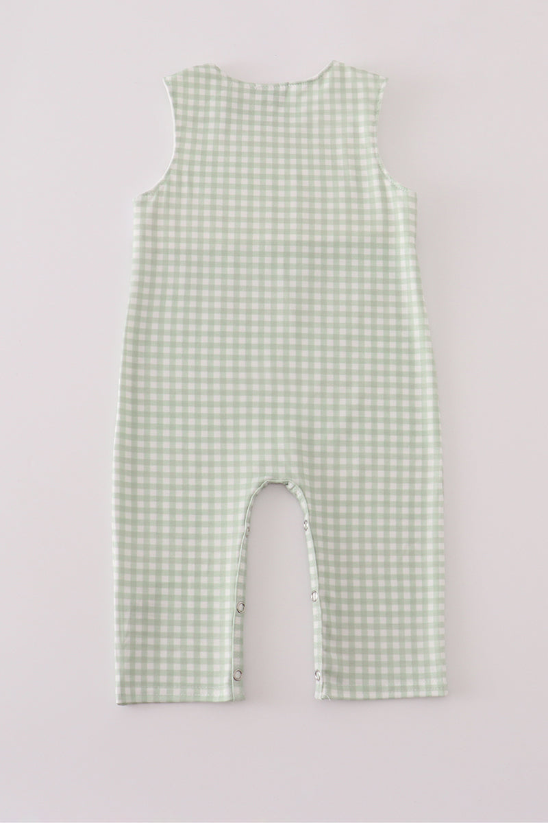 Green checkered romper on a light gray background