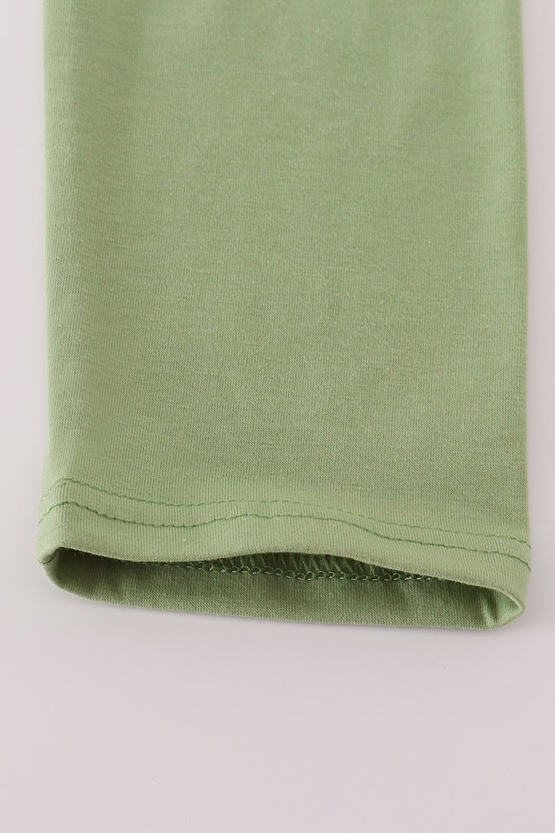Green fabric roll on a light gray background