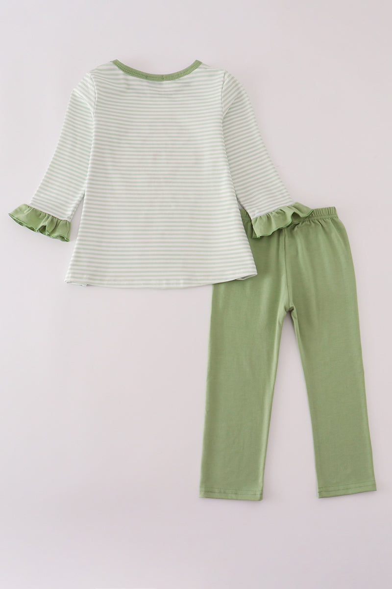 Green and white striped top with ruffled sleeves and green pants on a light gray background