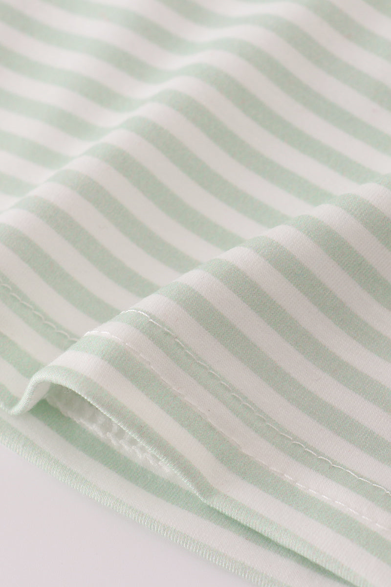 Close-up of light green fabric with white stripes