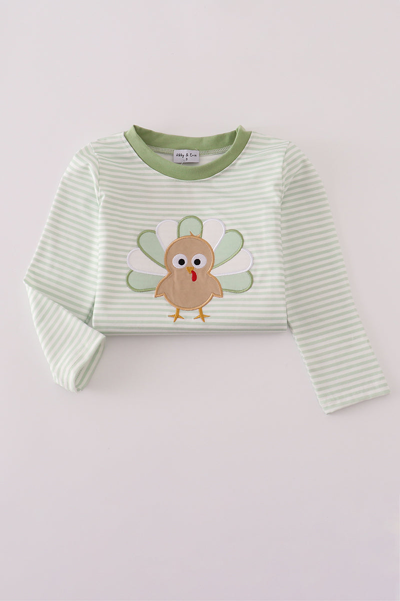 Green striped sweater with a cartoon turkey design on a light gray background