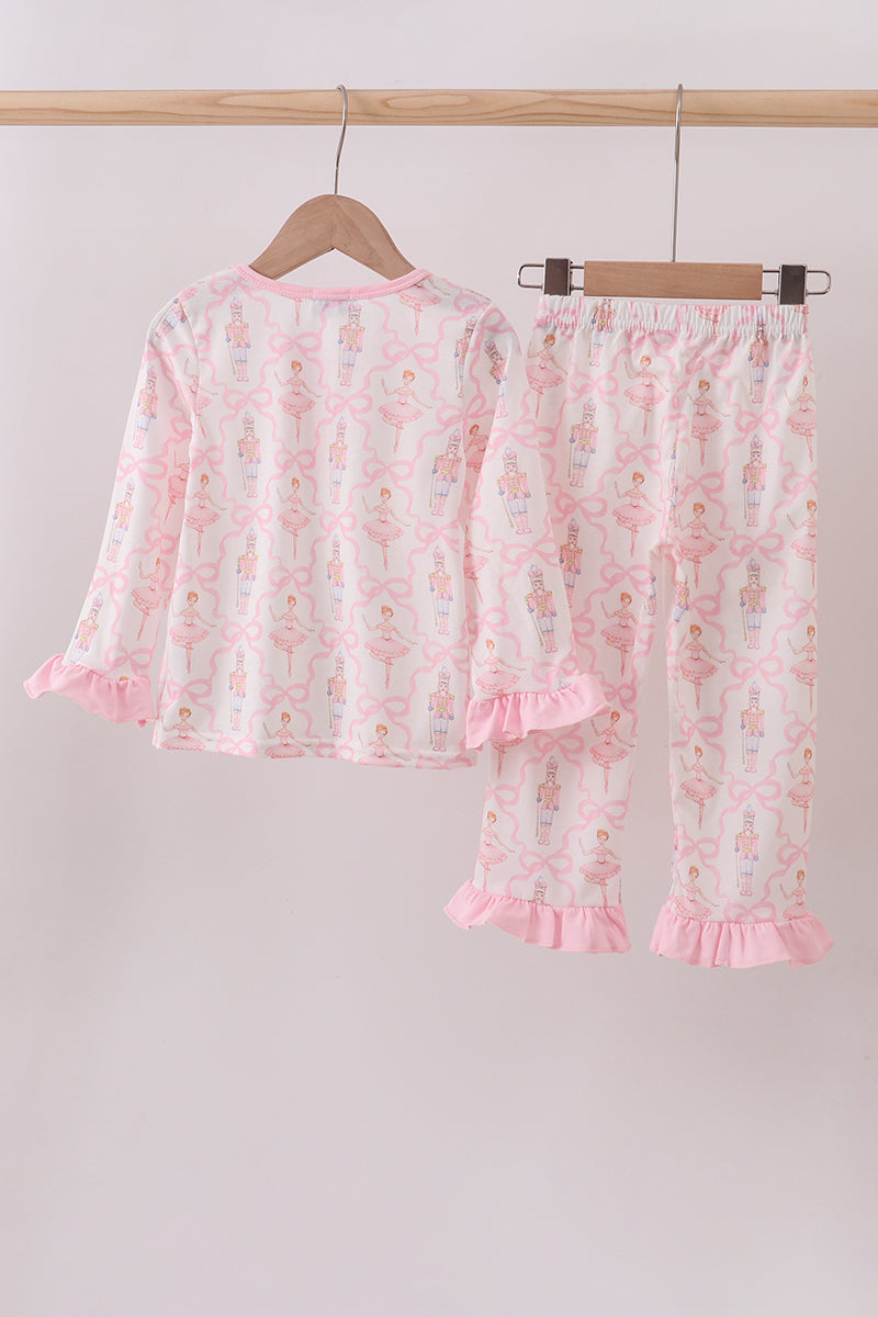 Floral pajama set with ruffles on a hanger against a plain background
