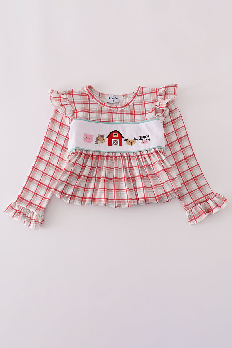 Red and white checkered dress with farm-themed design on a light gray background