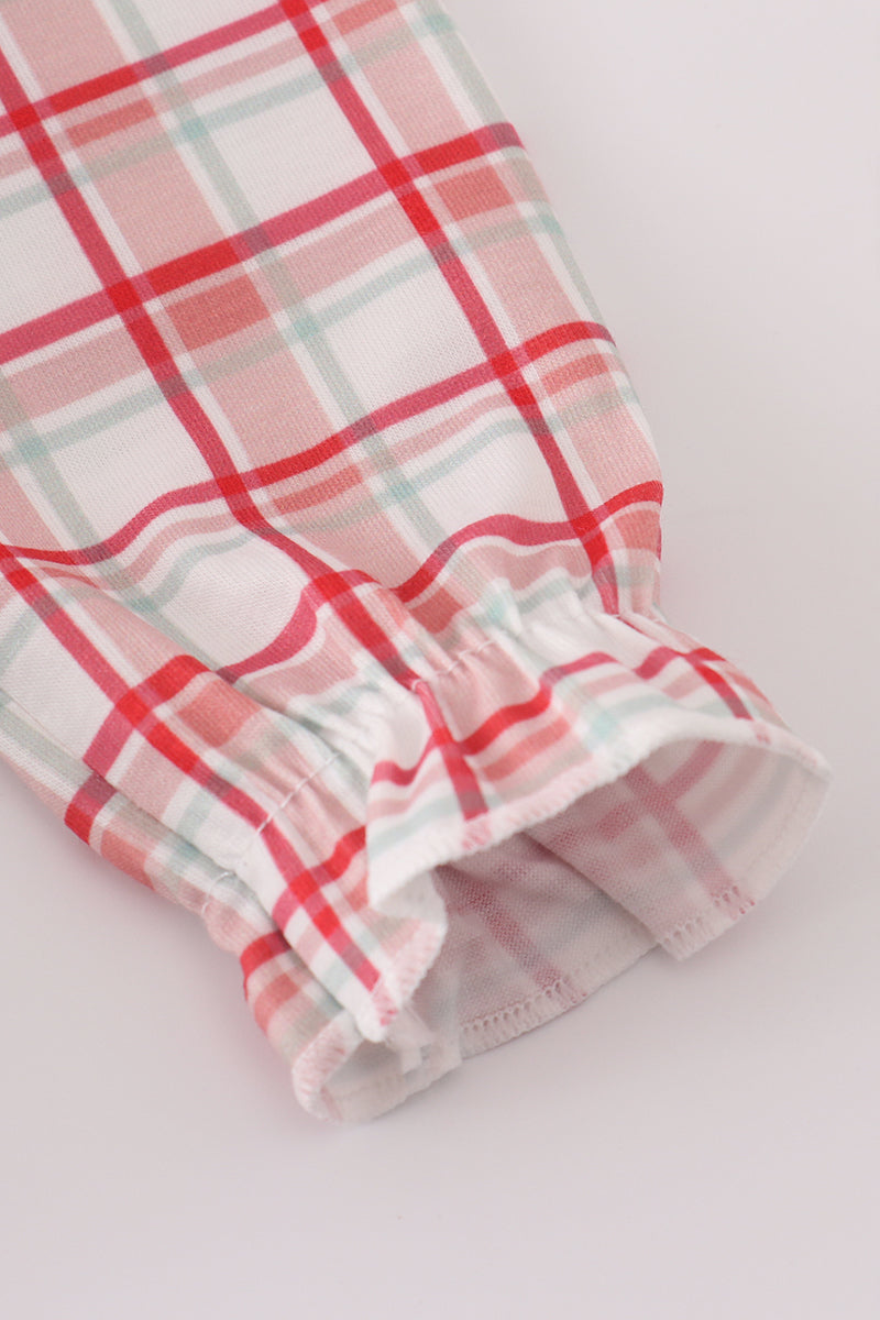 Plaid fabric with red and pink patterns on a white background