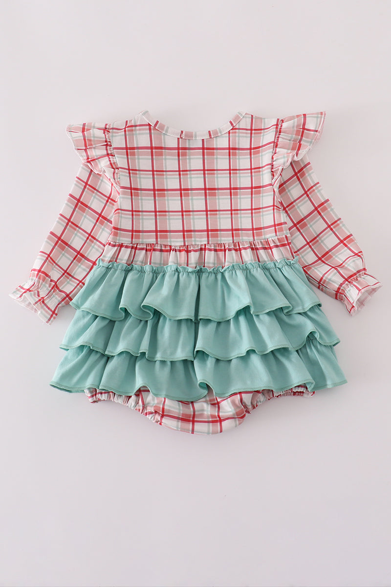 Children's outfit with plaid top and ruffled skirt on a white background
