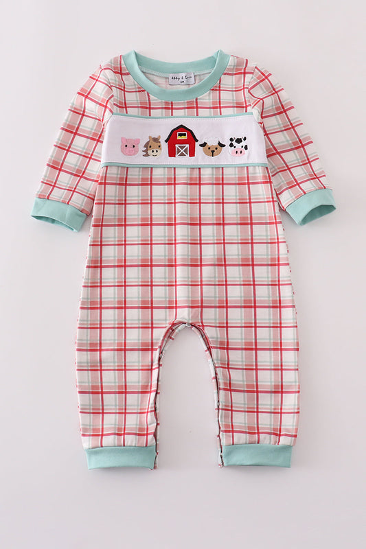 Plaid baby onesie with farm animal design on a white background