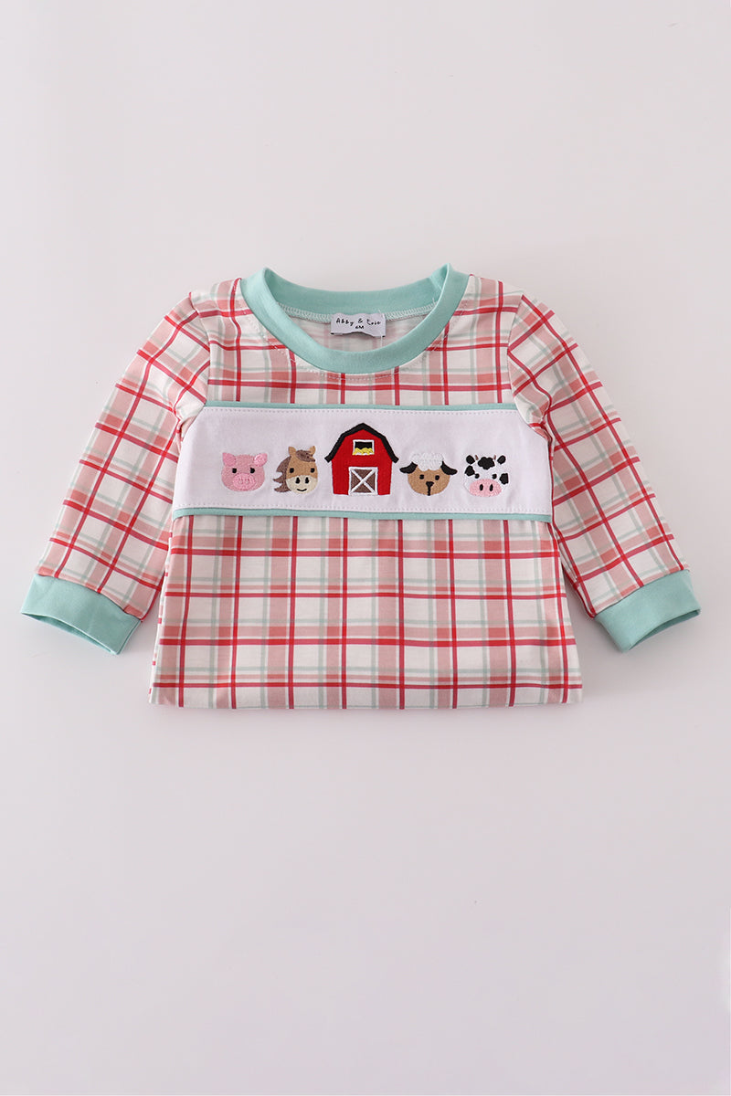 Plaid shirt with farm-themed design on a white background