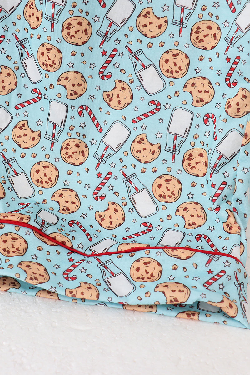 Fabric with cookies, milk bottles, and candy canes pattern on a light blue background