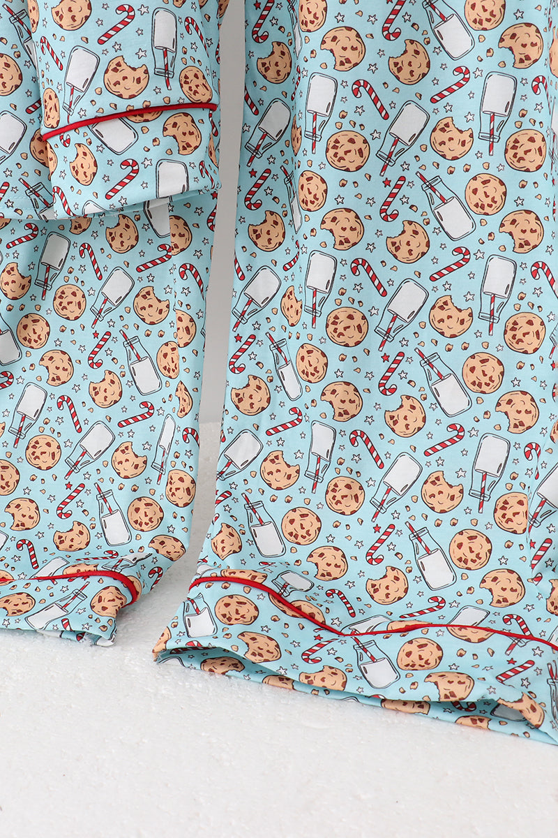 Pajama set with cookie and candy cane pattern on a light blue background