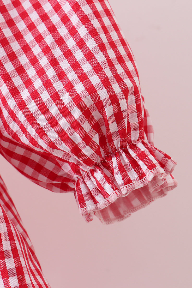 Red and white checkered fabric with ruffled edge on a pink background