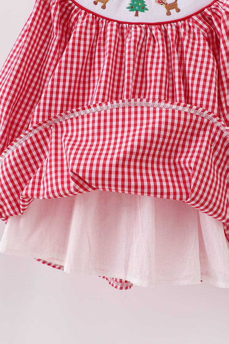 Red and white checkered dress with a white apron on a light gray background