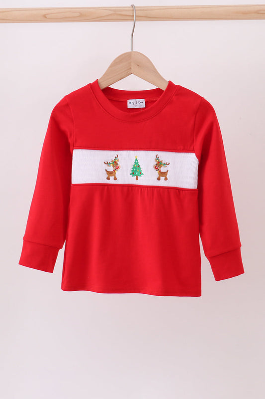 Red long-sleeve shirt with Christmas design on a hanger against a white background
