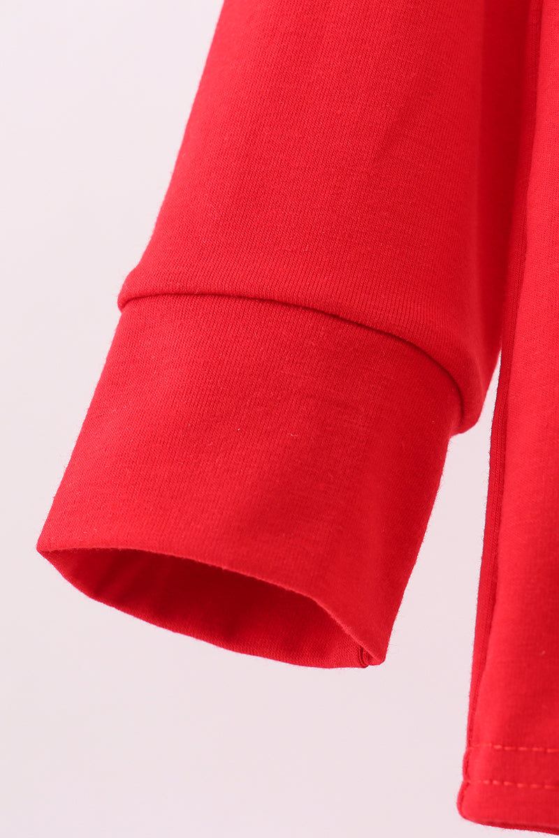 Close-up of a red sleeve on a light pink background