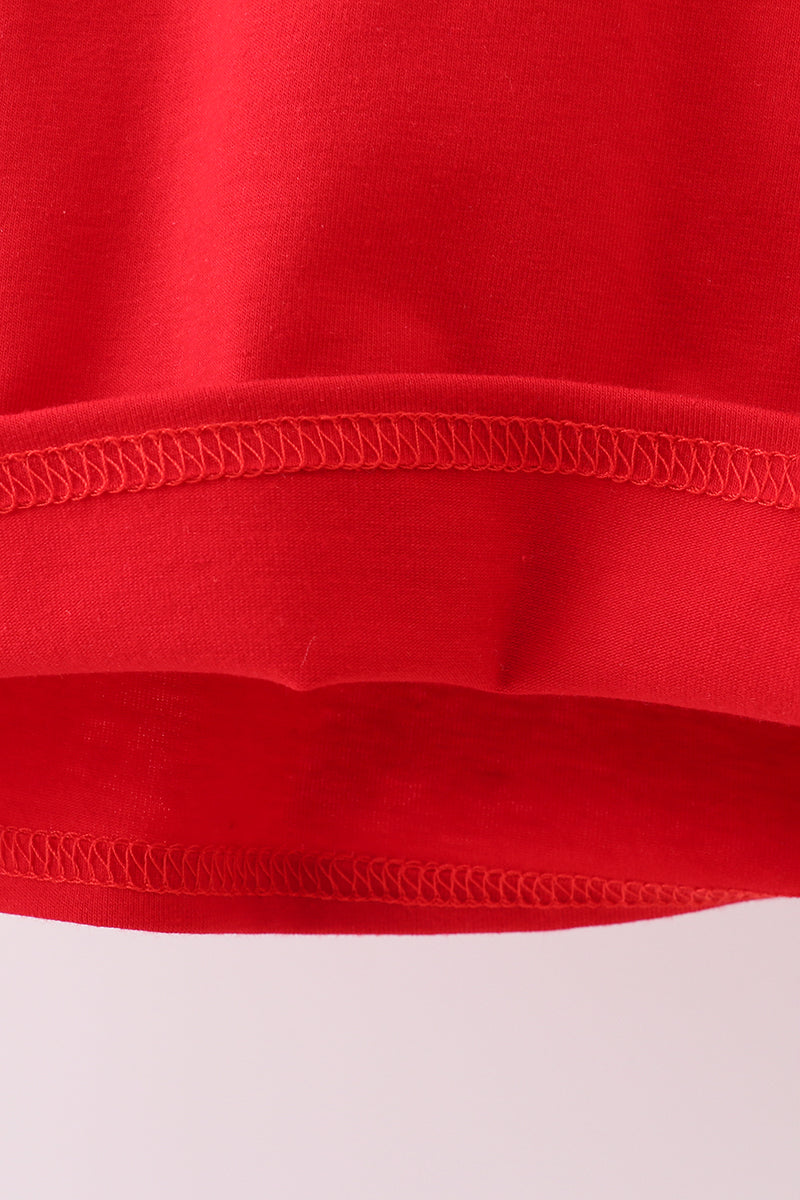 Close-up of a red fabric with visible stitching on a white background