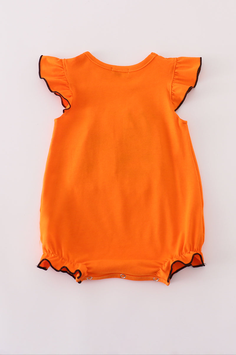 Orange dress with black trim on a white background