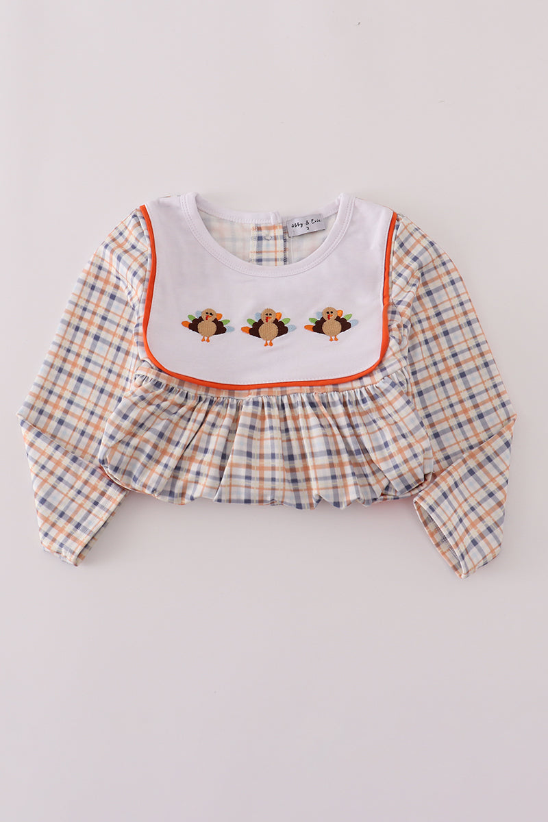 Plaid dress with embroidered details on a white background