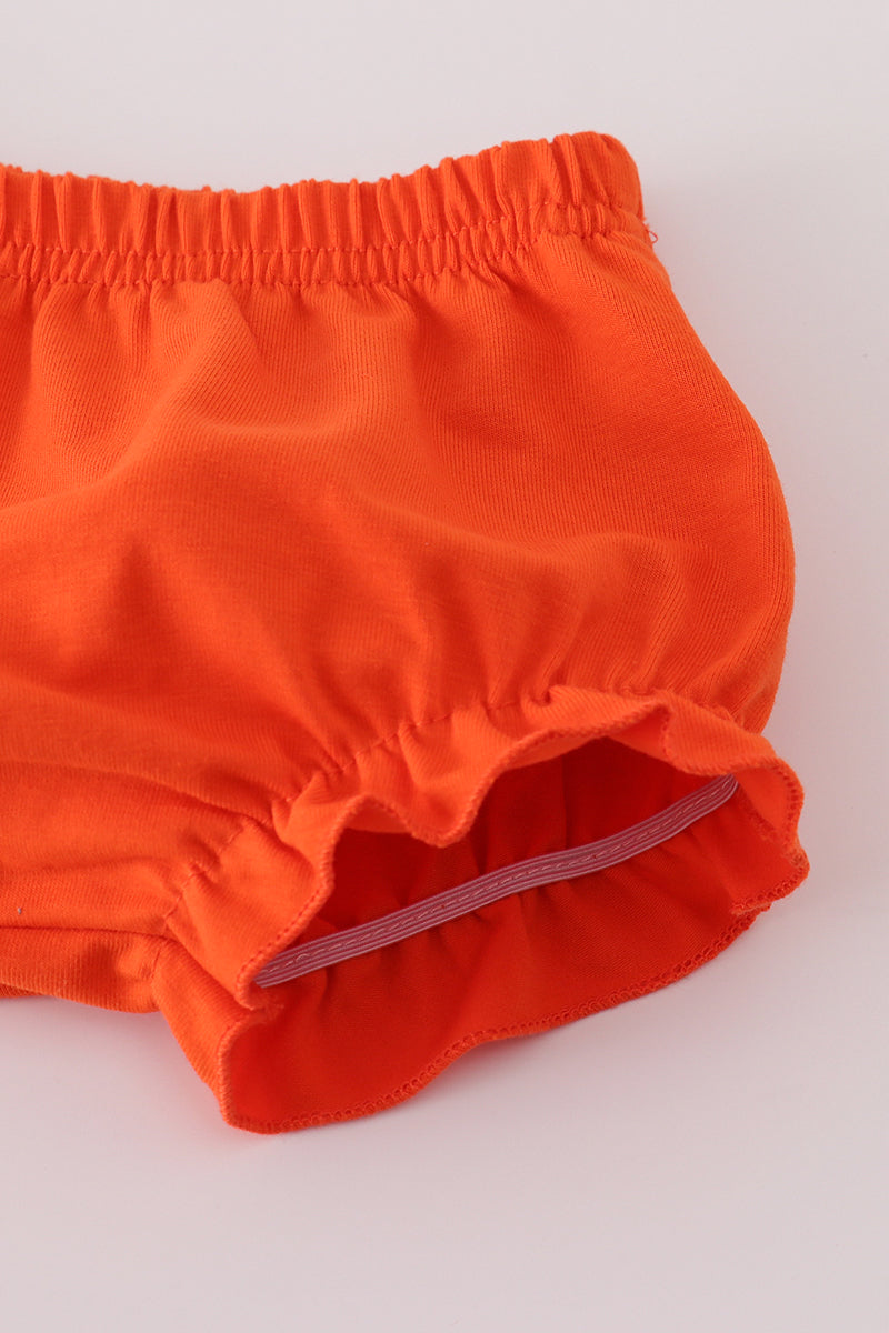 Orange baby bloomers on a white background