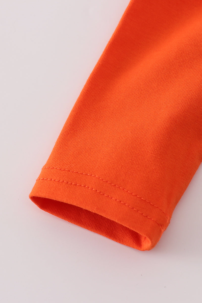 Close-up of an orange sleeve on a light gray background