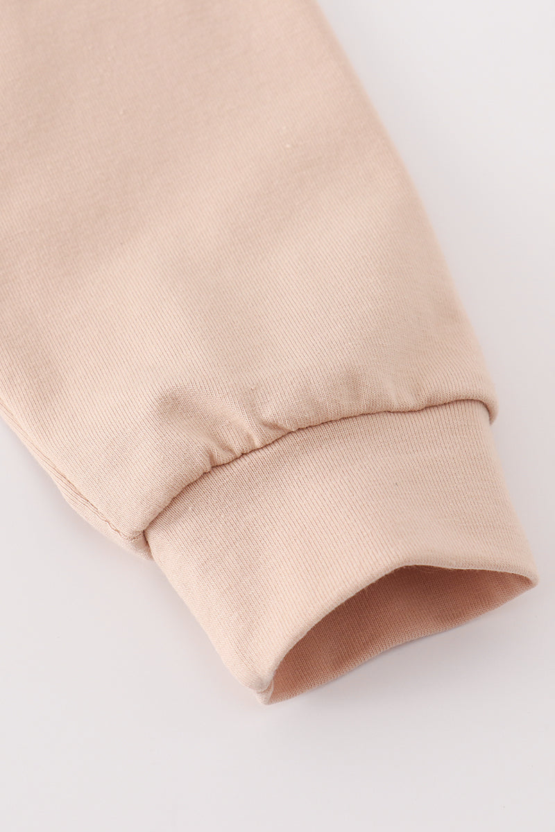 Close-up of a beige fabric sleeve on a light gray background