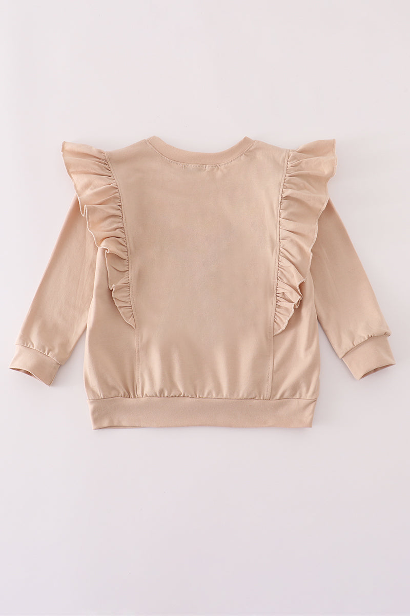 Beige satin top with ruffled shoulders on a white background