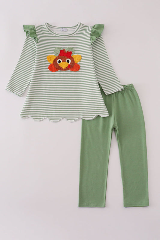 Green and white striped shirt with rooster design and green pants on a light gray background