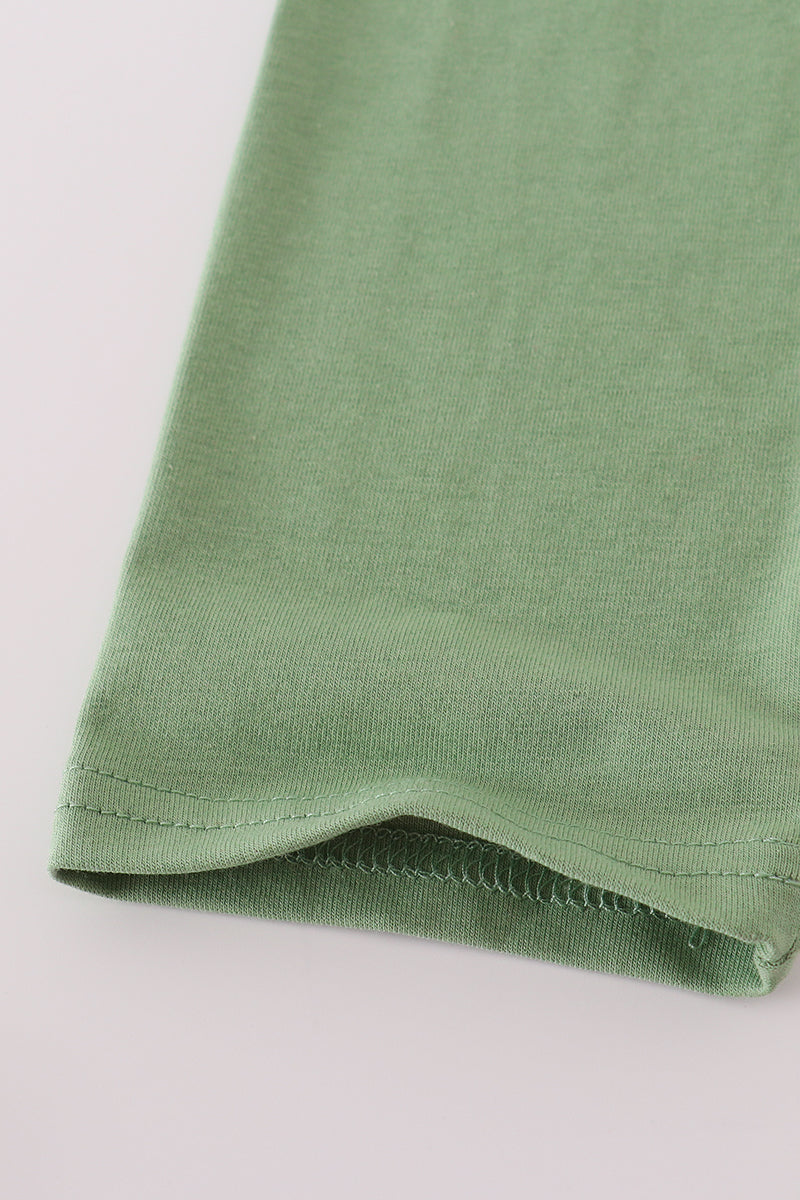 Close-up of a green fabric corner on a light gray background