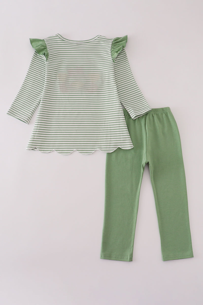 Green and white striped top with ruffled sleeves and matching pants on a light gray background