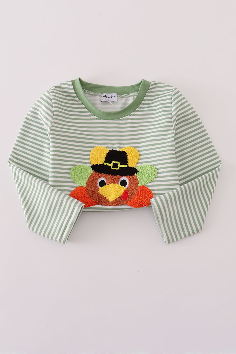 Green and white striped shirt with a embroidered turkey design on a light gray background
