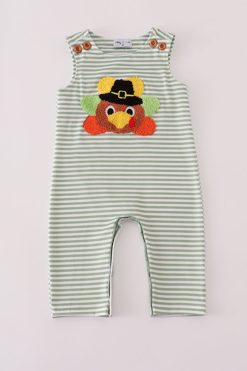 Green and white striped romper with a turkey design on a light gray background