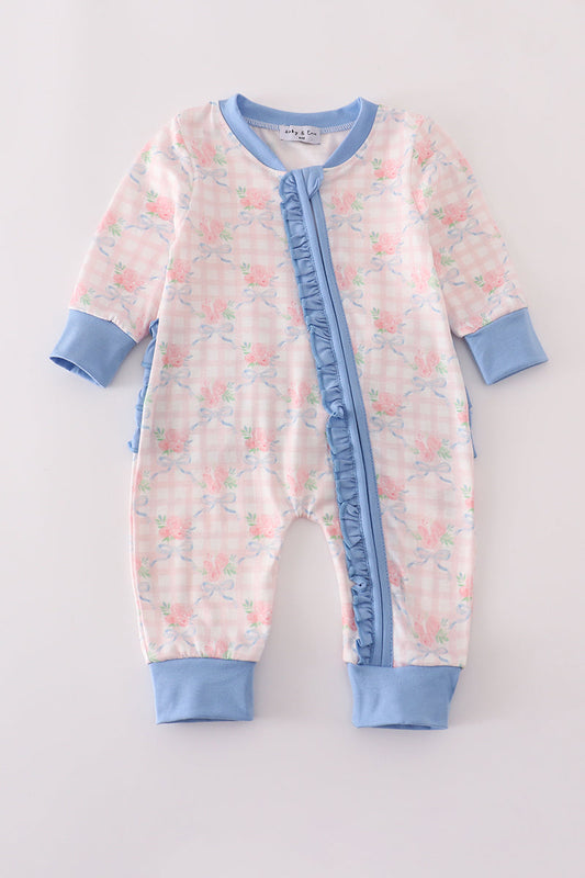 Baby onesie with floral pattern and blue accents on a light gray background
